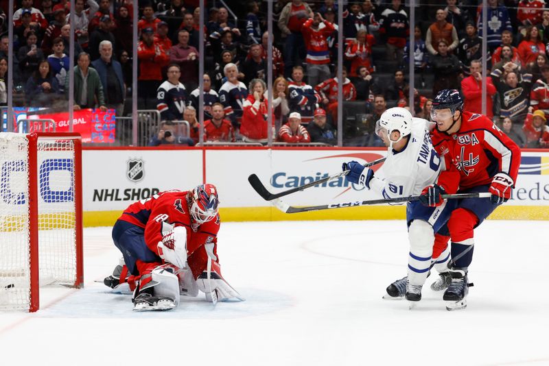 Nov 13, 2024; Washington, District of Columbia, USA; Toronto Maple Leafs center John Tavares (91) scores the game winning overtime goal on Washington Capitals goaltender Logan Thompson (48) as Capitals defenseman John Carlson (74) defends at Capital One Arena. Mandatory Credit: Geoff Burke-Imagn Images