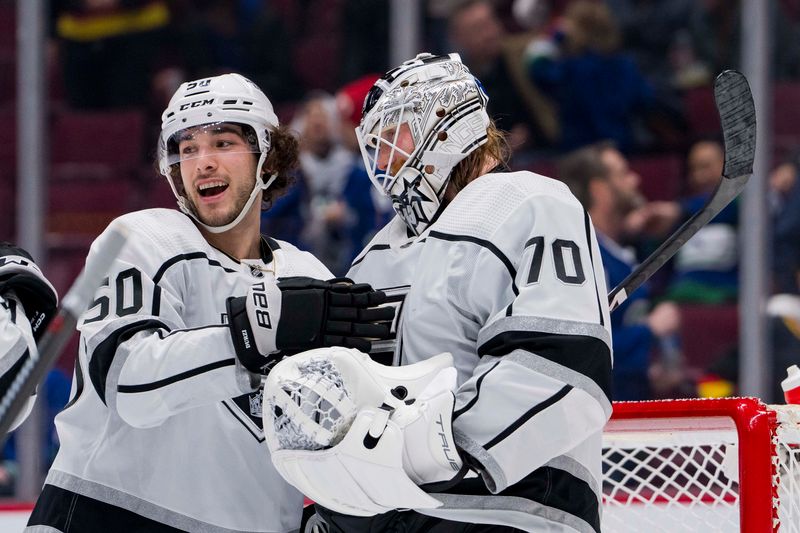 Apr 2, 2023; Vancouver, British Columbia, CAN; Los Angeles Kings defenseman Sean Durzi (50) and goalie Joonas Korpisalo (70) celebrate their victory against the Vancouver Canucks at Rogers Arena. Kings won 4-1. Mandatory Credit: Bob Frid-USA TODAY Sports