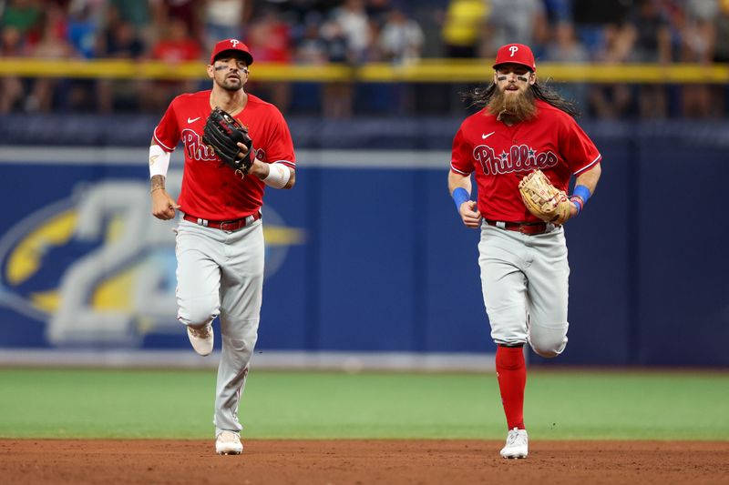 Jul 6, 2023; St. Petersburg, Florida, USA;  Philadelphia Phillies right fielder Nick Castellanos (8) and center fielder Brandon Marsh (16) run off the field against the Tampa Bay Rays in the eighth inning at Tropicana Field. Mandatory Credit: Nathan Ray Seebeck-USA TODAY Sports