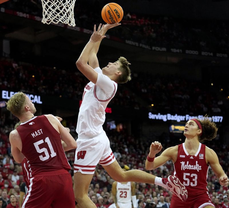 Jan 6, 2024; Madison, Wisconsin, USA; Wisconsin forward Nolan Winter (31) scores during the second half of their game  at Kohl Center. Mandatory Credit: Mark Hoffman-USA TODAY Sports