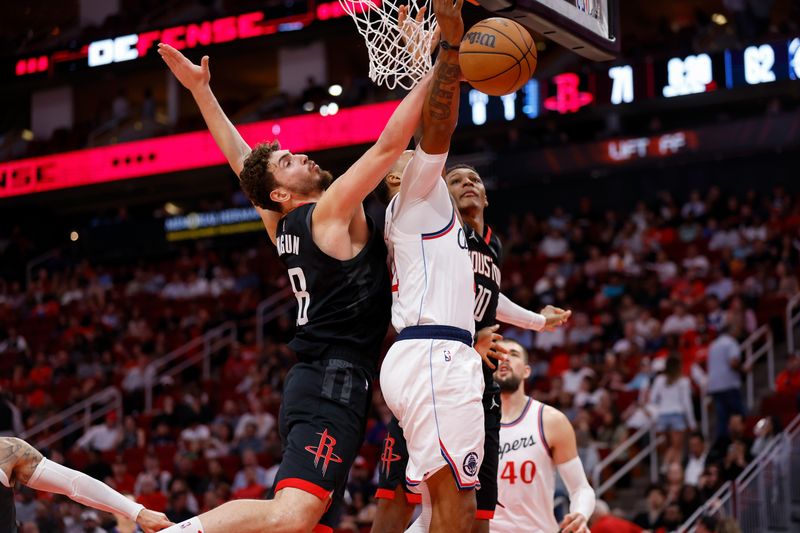 HOUSTON, TEXAS - NOVEMBER 13: Alperen Sengun #28 of the Houston Rockets defends a shot by Norman Powell #24 of the Los Angeles Clippers in the second half at Toyota Center on November 13, 2024 in Houston, Texas.  NOTE TO USER: User expressly acknowledges and agrees that, by downloading and or using this photograph, User is consenting to the terms and conditions of the Getty Images License Agreement.  (Photo by Tim Warner/Getty Images)