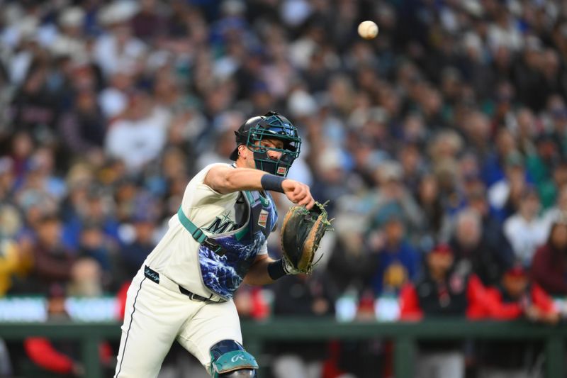 Mar 26, 2026; Seattle, Washington, USA; Seattle Mariners catcher Cal Raleigh (29) throws the ball to first base during the first inning against the Cleveland Guardians at T-Mobile Park. Mandatory Credit: Steven Bisig-Imagn Images