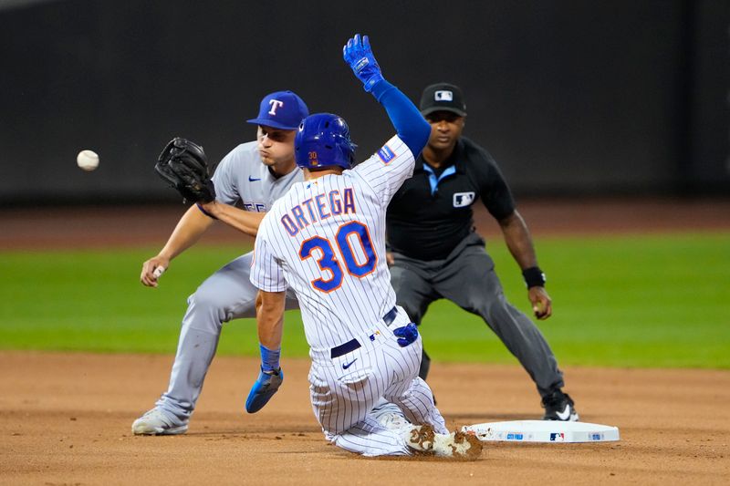 Aug 30, 2023; New York City, New York, USA;  New York Mets left fielder Rafael Ortega (30) is tagged out attempting to steal second base by Texas Rangers shortstop Corey Seager (5) after catching the throw during the fourth inning at Citi Field. Mandatory Credit: Gregory Fisher-USA TODAY Sports