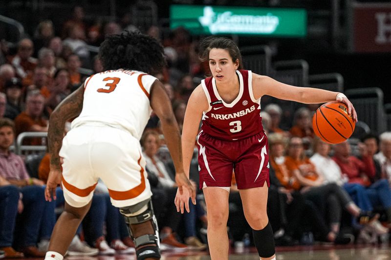 Jan 5, 2025; Austin, Texas, USA; Arkansas guard Izzy Higginbottom (3) is guarded by Texas Longhorns guard Rori Harmon (3) during the game at Moody Center. Mandatory Credit: Aaron E. Martinez/USA TODAY Network via Imagn Images