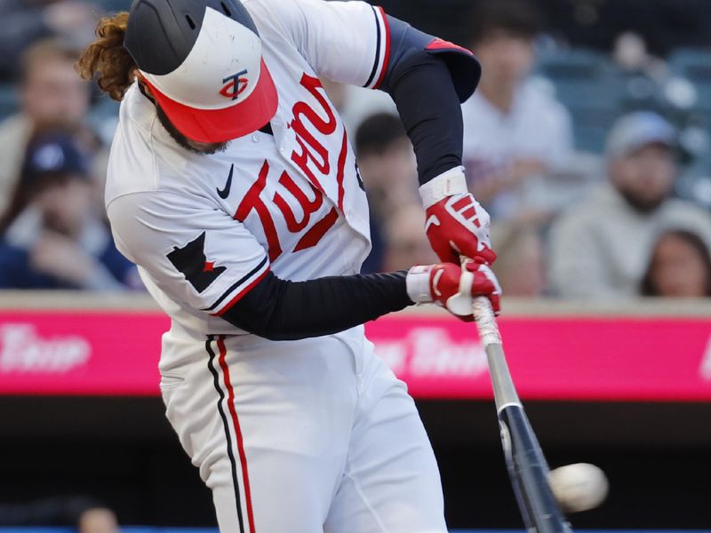 Apr 24, 2024; Minneapolis, Minnesota, USA; Minnesota Twins left fielder Austin Martin (82) doubles against the Chicago White Sox in the second inning at Target Field. Mandatory Credit: Bruce Kluckhohn-USA TODAY Sports