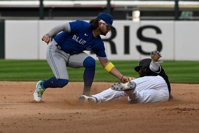 Jul 6, 2023; Chicago, Illinois, USA;  Chicago White Sox shortstop Elvis Andrus (1)  is caught stealing second base by Toronto Blue Jays shortstop Bo Bichette (11) during the sixth inning against the Toronto Blue Jays at Guaranteed Rate Field. Mandatory Credit: Matt Marton-USA TODAY Sports