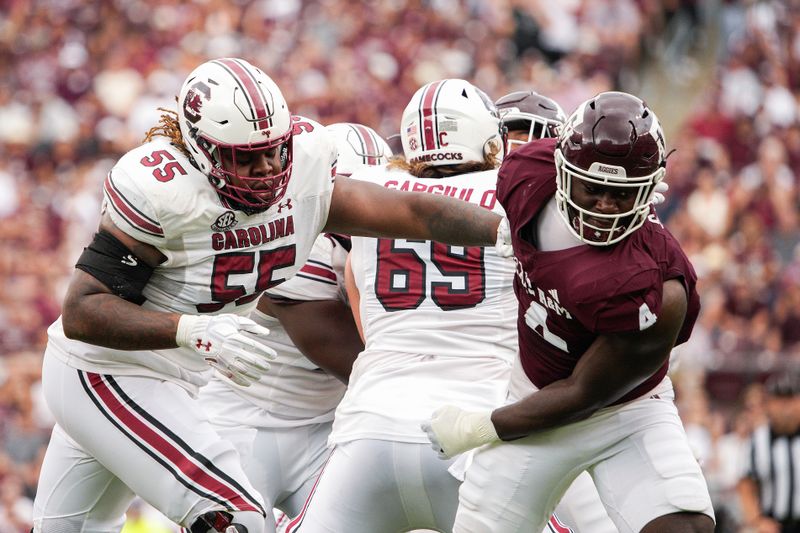 Oct 28, 2023; College Station, Texas, USA; South Carolina Gamecocks offensive lineman Jakai Moore (55) blocks Texas A&M Aggies defensive lineman Shemar Stewart (4) during the second quarter at Kyle Field. Mandatory Credit: Dustin Safranek-USA TODAY Sports