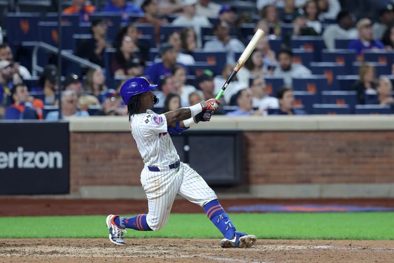 Sep 17, 2024; New York City, New York, USA; New York Mets shortstop Luisangel Acuna (2) follows through on a solo home run against the Washington Nationals during the eighth inning at Citi Field. The home run was the first of his major league career. Mandatory Credit: Brad Penner-Imagn Images