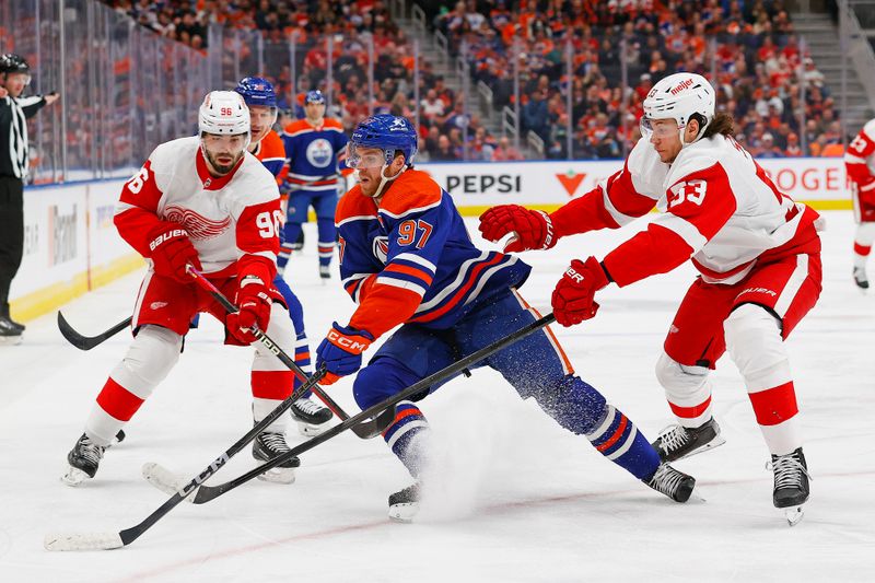 Feb 13, 2024; Edmonton, Alberta, CAN; Edmonton Oilers forward Connor McDavid (97) protects the puck from Detroit Red Wings defensemen Moritz Seider (53) and defensemen Jake Walman (96) at Rogers Place. Mandatory Credit: Perry Nelson-USA TODAY Sports