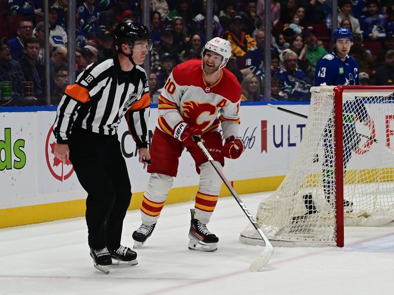 Mar 23, 2024; Vancouver, British Columbia, CAN; Calgary Flames forward Jonathan Huerdeau (10) has words for the referee against Vancouver Canucks during the second period at Rogers Arena. Mandatory Credit: Simon Fearn-USA TODAY Sports