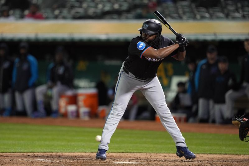 May 3, 2024; Oakland, California, USA; Miami Marlins designated hitter Josh Bell (9) is hit by a pitch during the eighth inning against the Oakland Athletics at Oakland-Alameda County Coliseum. Mandatory Credit: Darren Yamashita-USA TODAY Sports