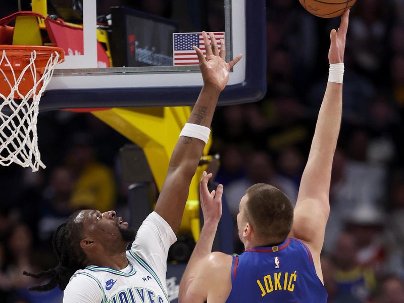 DENVER, COLORADO - MARCH 29: Nikola Jokic #15 of the Denver Nuggets puts up a shot over Naz Reid #11 of the Minnesota Timberwolves during the first quarter at Ball Arena on March 29, 2024 in Denver, Colorado. NOTE TO USER: User expressly acknowledges and agrees that, by downloading and or using this photograph, User is consenting to the terms and conditions of the Getty Images License Agreement.  (Photo by Matthew Stockman/Getty Images)