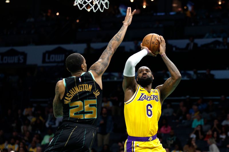 CHARLOTTE, NORTH CAROLINA - JANUARY 02: LeBron James #6 of the Los Angeles Lakers attempts a shot against P.J. Washington #25 of the Charlotte Hornets during the second half of the game at Spectrum Center on January 02, 2023 in Charlotte, North Carolina. NOTE TO USER: User expressly acknowledges and agrees that, by downloading and or using this photograph, User is consenting to the terms and conditions of the Getty Images License Agreement. (Photo by Jared C. Tilton/Getty Images)