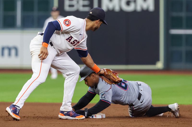 Jul 11, 2024; Houston, Texas, USA; Miami Marlins shortstop Xavier Edwards (63) steals second base against Houston Astros shortstop Jeremy Pena (3) in the sixth inning at Minute Maid Park. Mandatory Credit: Thomas Shea-USA TODAY Sports