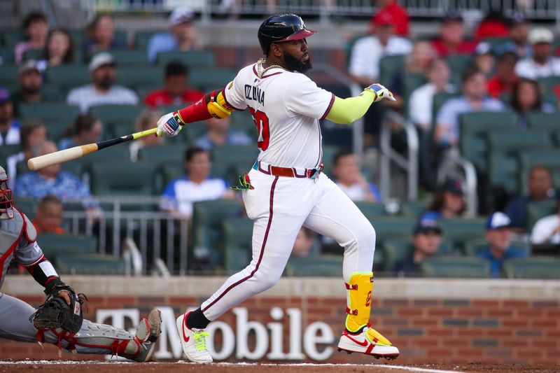 May 8, 2025; Atlanta, Georgia, USA; Atlanta Braves designated hitter Marcell Ozuna (20) hits a single against the Cincinnati Reds in the first inning at Truist Park. Mandatory Credit: Brett Davis-Imagn Images
