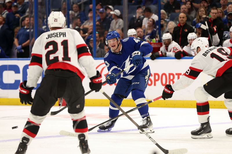 Apr 11, 2024; Tampa, Florida, USA; Tampa Bay Lightning defenseman Darren Raddysh (43) passes the puck as Ottawa Senators right wing Drake Batherson (19) and right wing Mathieu Joseph (21) defend during the third period at Amalie Arena. Mandatory Credit: Kim Klement Neitzel-USA TODAY Sports