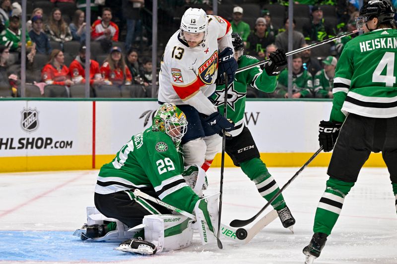 Mar 12, 2024; Dallas, Texas, USA; Dallas Stars goaltender Jake Oettinger (29) makes a stick save as Florida Panthers center Sam Reinhart (13) looks for the loose puck during the first period at the American Airlines Center. Mandatory Credit: Jerome Miron-USA TODAY Sports