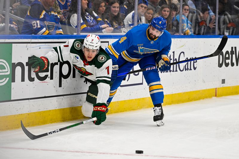 Mar 16, 2024; St. Louis, Missouri, USA;  St. Louis Blues defenseman Nick Leddy (4) defends against Minnesota Wild defenseman Brock Faber (7) during the first period at Enterprise Center. Mandatory Credit: Jeff Curry-USA TODAY Sports