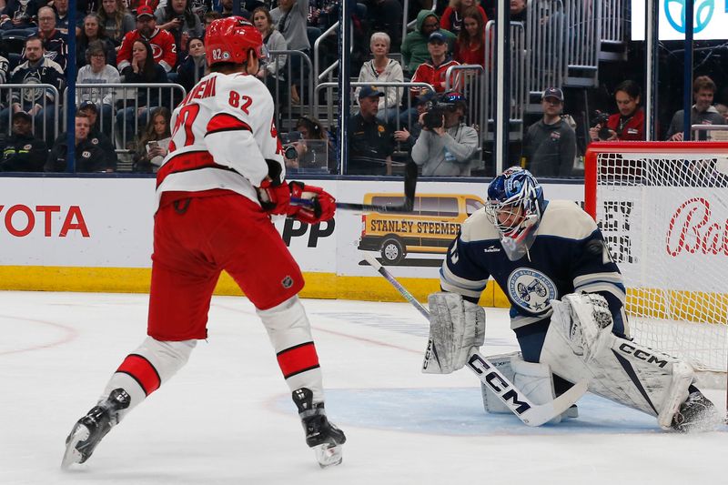 Apr 16, 2024; Columbus, Ohio, USA; Carolina Hurricanes center Jesperi Kotkaniemi (82) scores a goal past Columbus Blue Jackets goalie Jet Greaves (73) during the first period at Nationwide Arena. Mandatory Credit: Russell LaBounty-USA TODAY Sports