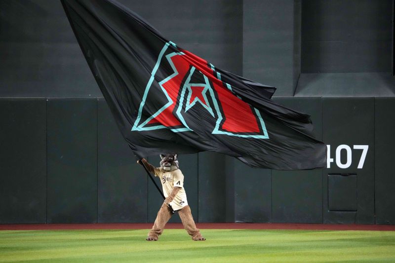 Aug 13, 2024; Phoenix, Arizona, USA; Arizona Diamondbacks mascot Baxter waves a team flag before the first inning of the game against the Colorado Rockies at Chase Field. Mandatory Credit: Joe Camporeale-USA TODAY Sports