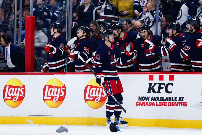 Jan 14, 2025; Winnipeg, Manitoba, CAN;  Winnipeg Jets forward Kyle Connor (81) celebrates with teammates after scoring a goal against the Vancouver Canucks during the first period at Canada Life Centre. Mandatory Credit: Terrence Lee-Imagn Images