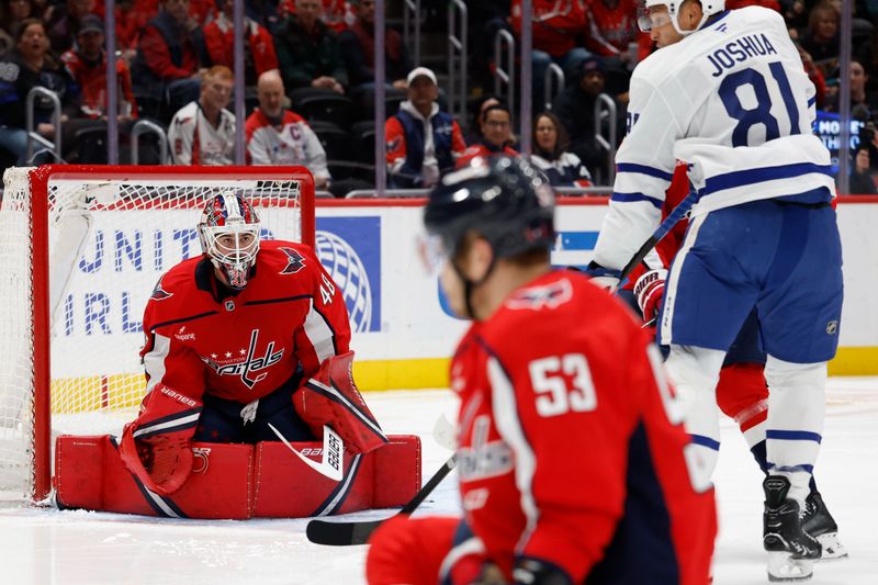 Dec 18, 2025; Washington, District of Columbia, USA; Washington Capitals goaltender Logan Thompson (48) prepares to make a save in front of Toronto Maple Leafs center Dakota Joshua (81) during the second period at Capital One Arena. Mandatory Credit: Geoff Burke-Imagn Images