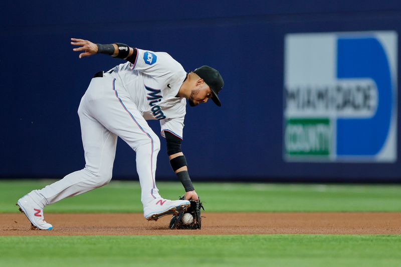 Jun 4, 2023; Miami, Florida, USA; Miami Marlins second baseman Luis Arraez (3) catches a ground ball prior to throwing it to first base to retire Oakland Athletics first baseman Ryan Noda (not pictured) during the first inning at loanDepot Park. Mandatory Credit: Sam Navarro-USA TODAY Sports