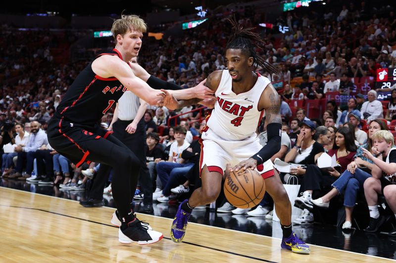 MIAMI, FLORIDA - APRIL 14: Delon Wright #4 of the Miami Heat drives against Gradey Dick #1 of the Toronto Raptors during the second quarter of the game at Kaseya Center on April 14, 2024 in Miami, Florida. NOTE TO USER: User expressly acknowledges and agrees that, by downloading and or using this photograph, User is consenting to the terms and conditions of the Getty Images License Agreement. (Photo by Megan Briggs/Getty Images)