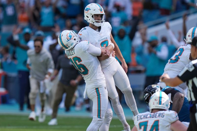 Miami Dolphins punter Jake Bailey (16) lifts place kicker Jason Sanders (7) after Sanders kicked the winning field goal during the second half of an NFL football game against the Jacksonville Jaguars, Sunday, Sept. 8, 2024, in Miami Gardens, Fla. The Dolphins defeated the Jaguars 20-17. (AP Photo/Wilfredo Lee)