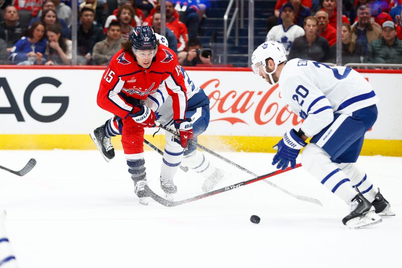 Mar 20, 2024; Washington, District of Columbia, USA; Washington Capitals left wing Sonny Milano (15) battles for the puck with Toronto Maple Leafs defenseman Joel Edmundson (20) during the first period at Capital One Arena. Mandatory Credit: Amber Searls-USA TODAY Sports