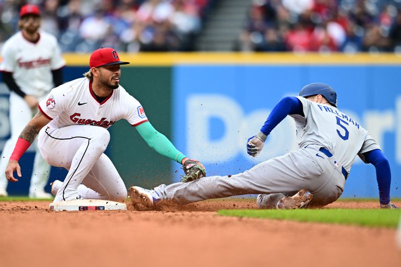 May 28, 2025; Cleveland, Ohio, USA; Cleveland Guardians shortstop Gabriel Arias (13) tags out Los Angeles Dodgers first baseman Freddie Freeman (5) during the eighth inning at Progressive Field. Mandatory Credit: Ken Blaze-Imagn Images