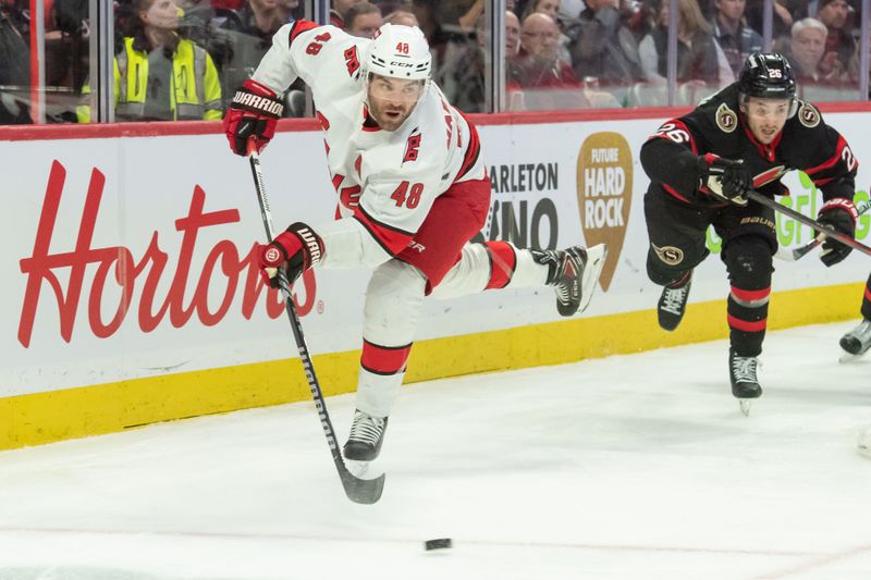 Dec 12, 2023; Ottawa, Ontario, CAN; Carolina Hurricanes  left wing Jordan Martinook (42) moves the puck in the second period against the Ottawa Senators at the Canadian Tire Centre. Mandatory Credit: Marc DesRosiers-USA TODAY Sports