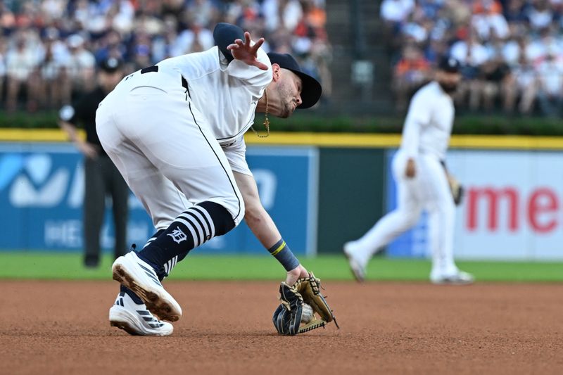 Jun 29, 2025; Detroit, Michigan, USA; Detroit Tigers third baseman Zach McKinstry (39) field the ball on a short hop before throwing out a Minnesota Twins baserunner at first base in the sixth inning at Comerica Park. Mandatory Credit: Lon Horwedel-Imagn Images