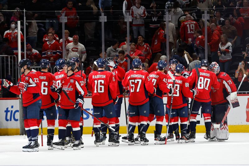 Oct 31, 2024; Washington, District of Columbia, USA; Washington Capitals players celebrate after their game against the Montreal Canadiens at Capital One Arena. Mandatory Credit: Geoff Burke-Imagn Images