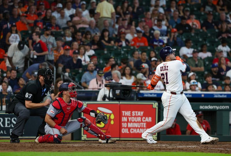 Jul 30, 2025; Houston, Texas, USA; Houston Astros catcher Yainer Diaz (21) hits a three run home run against the Washington Nationals in the sixth inning at Daikin Park. Mandatory Credit: Thomas Shea-Imagn Images