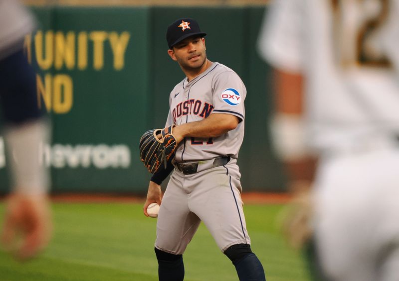 Jul 22, 2024; Oakland, California, USA; Houston Astros second baseman Jose Altuve (27) between plays against the Oakland Athletics during the fourth inning at Oakland-Alameda County Coliseum. Mandatory Credit: Kelley L Cox-USA TODAY Sports