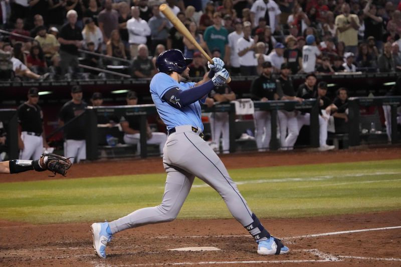 Jun 28, 2023; Phoenix, Arizona, USA; Tampa Bay Rays right fielder Josh Lowe (15) hits a two RBI double against the Arizona Diamondbacks during the ninth inning at Chase Field. Mandatory Credit: Joe Camporeale-USA TODAY Sports