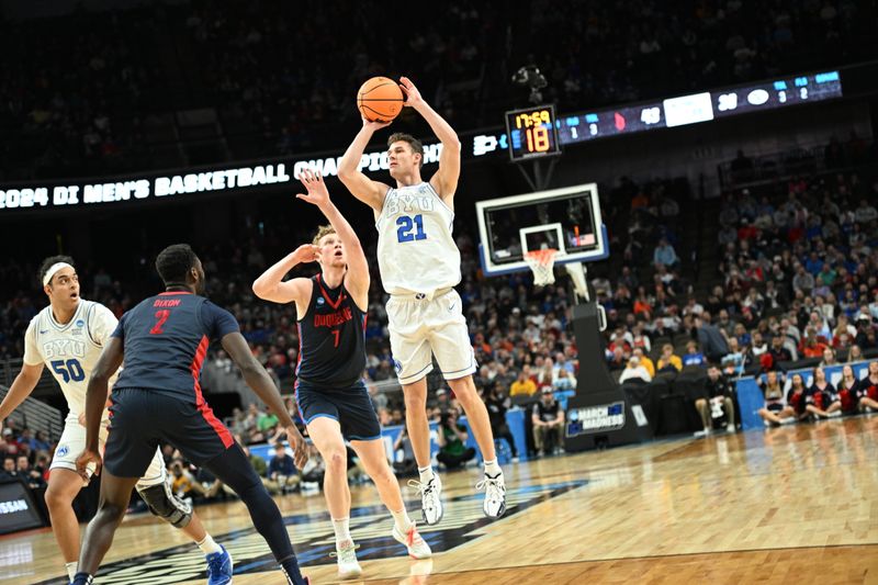 Mar 21, 2024; Omaha, NE, USA; Brigham Young Cougars guard Trevin Knell (21) shoots against Duquesne Dukes forward Jakub Necas (7) in the second half during the first round of the NCAA Tournament at CHI Health Center Omaha. Mandatory Credit: Steven Branscombe-USA TODAY Sports