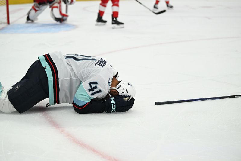 Oct 24, 2023; Detroit, Michigan, USA; Seattle Kraken left wing Pierre-Edouard Bellemare (41) struggles to get off the ice after being injured against the Detroit Red Wings in the first period at Little Caesars Arena. Mandatory Credit: Lon Horwedel-USA TODAY Sports