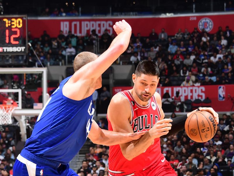 LOS ANGELES, CA - MARCH 27: Nikola Vucevic #9 of the Chicago Bulls moves the ball during the game against the LA Clippers on March 27, 2023 at Crypto.Com Arena in Los Angeles, California. NOTE TO USER: User expressly acknowledges and agrees that, by downloading and/or using this Photograph, user is consenting to the terms and conditions of the Getty Images License Agreement. Mandatory Copyright Notice: Copyright 2023 NBAE (Photo by Adam Pantozzi/NBAE via Getty Images)