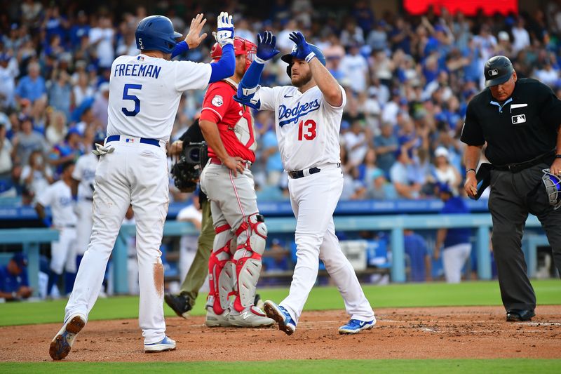 Jul 29, 2023; Los Angeles, California, USA; Los Angeles Dodgers third baseman Max Muncy (13) is greeted by first baseman Freddie Freeman (5) after hitting a two run home run against the Cincinnati Reds during the first inning at Dodger Stadium. Mandatory Credit: Gary A. Vasquez-USA TODAY Sports