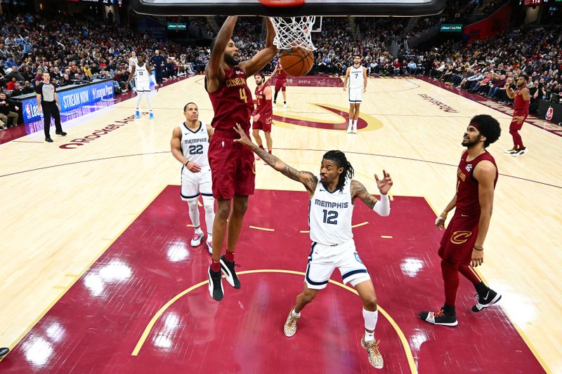 CLEVELAND, OHIO - FEBRUARY 23: Evan Mobley #4 of the Cleveland Cavaliers dunks over Ja Morant #12 of the Memphis Grizzlies during the fourth quarter at Rocket Arena on February 23, 2025 in Cleveland, Ohio. The Cavaliers defeated the Grizzlies 129-123. NOTE TO USER: User expressly acknowledges and agrees that, by downloading and or using this photograph, User is consenting to the terms and conditions of the Getty Images License Agreement. (Photo by Jason Miller/Getty Images)