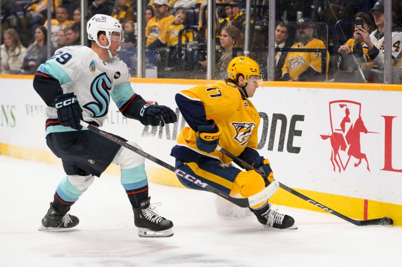 Mar 6, 2025; Nashville, Tennessee, USA;  Nashville Predators center Mark Jankowski (17) and Seattle Kraken defenseman Vince Dunn (29) battle for the puck during the first period at Bridgestone Arena. Mandatory Credit: Steve Roberts-Imagn Images