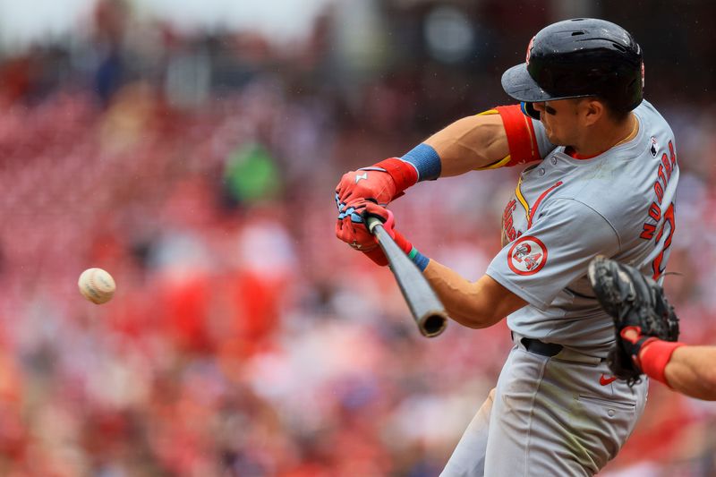 May 29, 2024; Cincinnati, Ohio, USA; St. Louis Cardinals outfielder Lars Nootbaar (21) hits a single against the Cincinnati Reds in the seventh inning at Great American Ball Park. Mandatory Credit: Katie Stratman-USA TODAY Sports