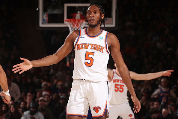 NEW YORK, NY - DECEMBER 25: Immanuel Quickley #5 of the New York Knicks high fives teammate during the game against the Milwaukee Bucks on December 25, 2023 at Madison Square Garden in New York City, New York.  NOTE TO USER: User expressly acknowledges and agrees that, by downloading and or using this photograph, User is consenting to the terms and conditions of the Getty Images License Agreement. Mandatory Copyright Notice: Copyright 2023 NBAE  (Photo by Nathaniel S. Butler/NBAE via Getty Images)