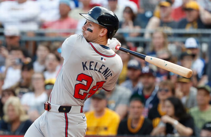 May 25, 2024; Pittsburgh, Pennsylvania, USA;  Atlanta Braves left fielder Jarred Kelenic (24) hits an RBI single against the Pittsburgh Pirates during the fourth inning at PNC Park. Mandatory Credit: Charles LeClaire-USA TODAY Sports