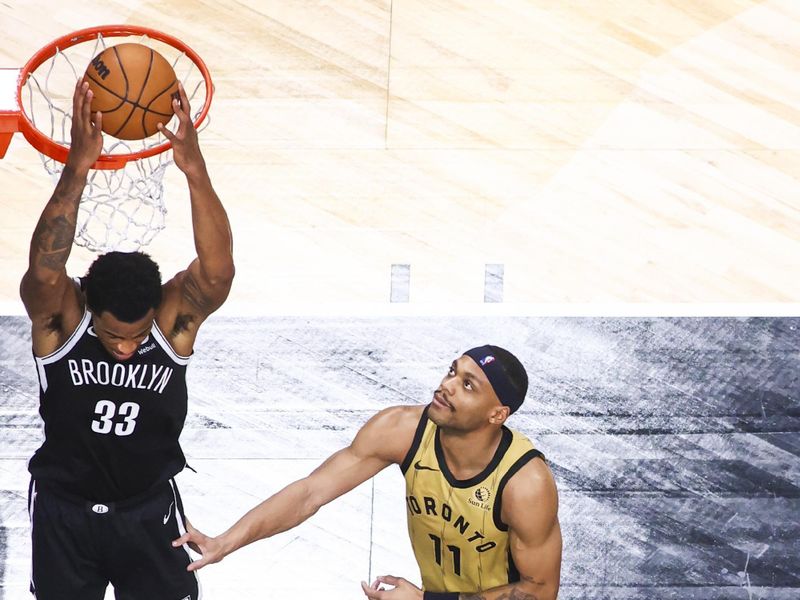 TORONTO, CANADA - FEBRUARY 22: Nicolas Claxton #33 of the Brooklyn Nets dunks the ball during the game against the Toronto Raptors on February 22, 2024 at the Scotiabank Arena in Toronto, Ontario, Canada.  NOTE TO USER: User expressly acknowledges and agrees that, by downloading and or using this Photograph, user is consenting to the terms and conditions of the Getty Images License Agreement.  Mandatory Copyright Notice: Copyright 2024 NBAE (Photo by Vaughn Ridley/NBAE via Getty Images)