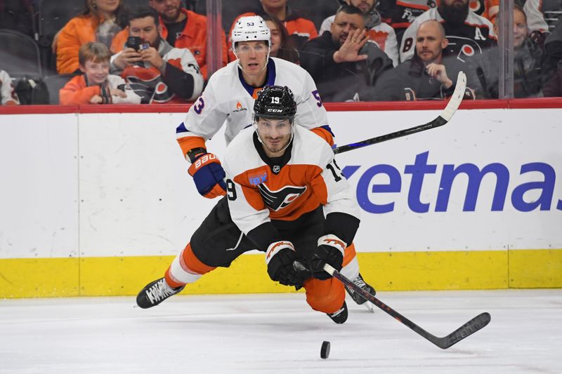 Jan 30, 2025; Philadelphia, Pennsylvania, USA; Philadelphia Flyers right wing Garnet Hathaway (19) dives for loose puck in front of New York Islanders center Casey Cizikas (53) during the second period at Wells Fargo Center. Mandatory Credit: Eric Hartline-Imagn Images