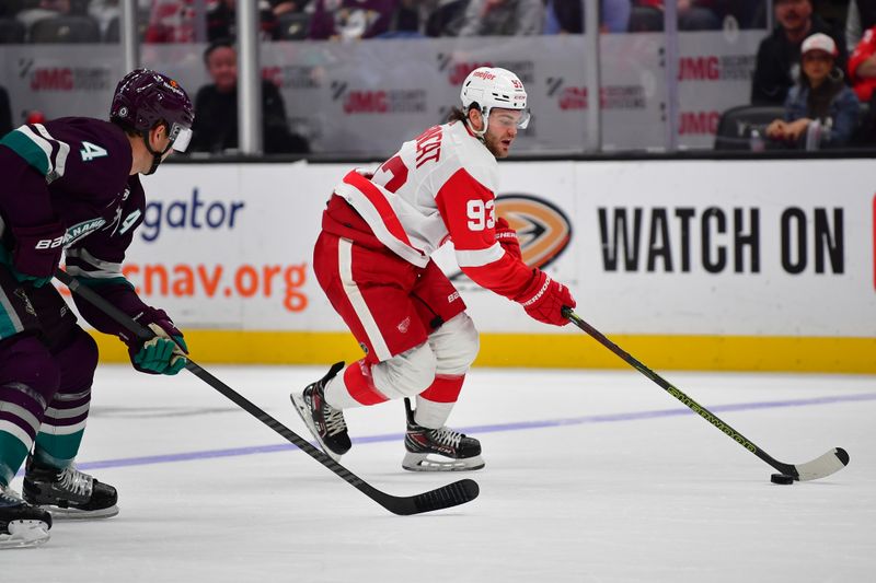 Jan 7, 2024; Anaheim, California, USA; Detroit Red Wings right wing Alex DeBrincat (93) moves the puck ahead of Anaheim Ducks defenseman Cam Fowler (4) during the third period at Honda Center. Mandatory Credit: Gary A. Vasquez-USA TODAY Sports