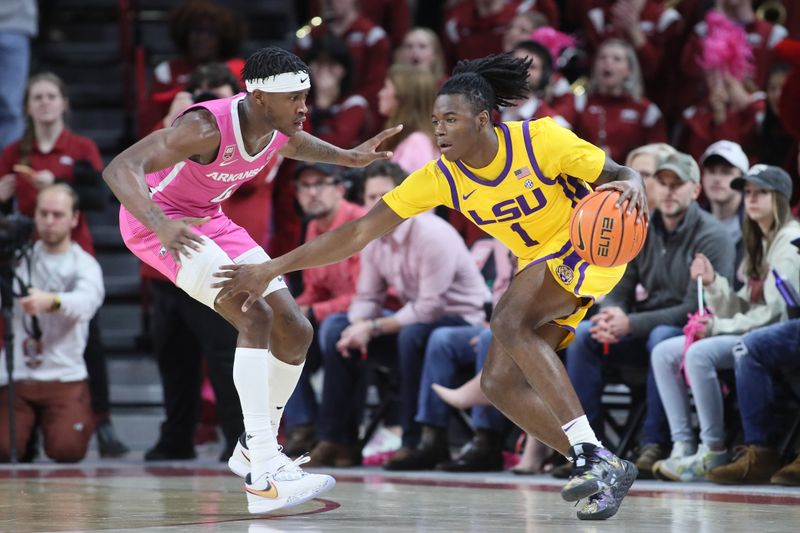 Jan 24, 2023; Fayetteville, Arkansas, USA; LSU Tigers guard Cam Hayes (1) dribbles as Arkansas Razorbacks guard Davonte Davis (4) defends during the second half at Bud Walton Arena. Arkansas won 60-40. Mandatory Credit: Nelson Chenault-USA TODAY Sports